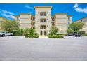 Exterior view of a three-story building with parking in front at 9203 Griggs Rd # B302, Englewood, FL 34224