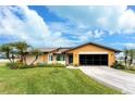 Single story home with a large grassy yard and screened garage at 9822 Gulfstream Blvd, Englewood, FL 34224