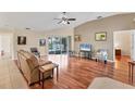 Spacious living room with hardwood floors, and access to a patio at 11091 Corrigan Ave, Englewood, FL 34224