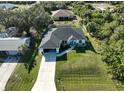 Housetop view showing house, driveway, and surrounding landscape at 12063 Claremont Dr, Port Charlotte, FL 33981