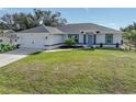 Newly built home with attached garage and well-manicured lawn at 12063 Claremont Dr, Port Charlotte, FL 33981
