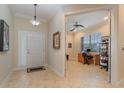 Bright and airy entryway with tile floors, leading to an office and entry door at 13048 Creekside Ln, Port Charlotte, FL 33953
