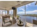 Bright living room with water views and access to a screened balcony at 13213 Gasparilla Rd # B601, Placida, FL 33946
