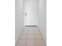 Simple entryway with tile floors and a white door at 150 Englewood Isles Pkwy # 507, Englewood, FL 34223