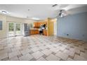Open living room and kitchen with tiled floors at 15120 Payne St, Punta Gorda, FL 33955