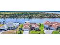Waterfront home with a red door and a private dock, offering scenic views of the surrounding canal at 15361 Visalia Rd, Port Charlotte, FL 33981
