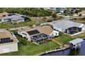 Waterfront home featuring a private dock, screened-in pool, solar panels and lush landscaping at 15361 Visalia Rd, Port Charlotte, FL 33981