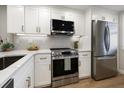 Updated kitchen featuring stainless steel appliances and white shaker cabinets at 1751 Beach Rd # 403, Englewood, FL 34223