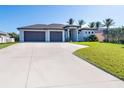 Two-car garage and nicely landscaped lawn at 226 Rotonda N Blvd, Rotonda West, FL 33947