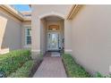Front entry with arched doorway, terracotta tile flooring, and seating area at 2744 Mill Creek Rd, Port Charlotte, FL 33953