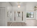 Bright foyer featuring gray floors, a closet, and a light fixture that is centrally located at 3568 Middletown St, Port Charlotte, FL 33952