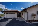 Attached garage with a spacious driveway and neatly landscaped yard at 365 Englewood Isles Pkwy # 3, Englewood, FL 34223