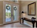 Bright entryway with double doors and a console table, creating a welcoming atmosphere at 4233 Grosse Pointe Dr, Port Charlotte, FL 33953