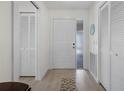 Light and airy entryway with built-in storage and wood-look flooring at 660 Linden Dr, Englewood, FL 34223