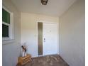 White front door entryway with glass sidelights, leading into the home at 660 Linden Dr, Englewood, FL 34223