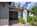 Inviting front entrance with a pergola and nicely landscaped area at 660 Linden Dr, Englewood, FL 34223