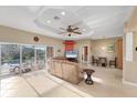 Spacious living room with leather couches, a flat-screen TV, and pool access at 7257 Bridgeport Ln, Englewood, FL 34224