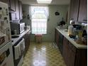 Galley kitchen with ample counter space and appliances at 914 E 2Nd St, Englewood, FL 34223