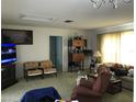 Bright living room with comfy seating and large TV at 914 E 2Nd St, Englewood, FL 34223