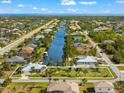 Property view showcasing house, canal, and neighborhood at 10322 Sunbury Dr, Port Charlotte, FL 33981