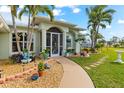 Landscaped front yard with a walkway leading to the front door at 10322 Sunbury Dr, Port Charlotte, FL 33981