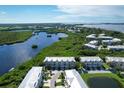 Expansive aerial view showcasing a waterfront community of townhouses at 10360 Longshore Rd # 66, Placida, FL 33946