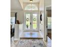 Bright and airy entryway with double doors opening to a backyard view at 1042 Boundary Blvd, Rotonda West, FL 33947