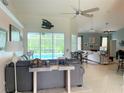 Spacious living room with a view of the pool and lanai at 1042 Boundary Blvd, Rotonda West, FL 33947