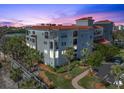 Building at dusk, showcasing architectural details and landscaping at 11200 Hacienda Del Mar Blvd # 201, Placida, FL 33946