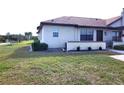 Side view of villa showcasing a private backyard and landscaping at 13100 S Mccall Rd # 110, Port Charlotte, FL 33981