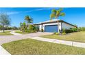 House exterior showcasing a paver driveway, landscaping, and a blue garage door at 1506 Hyssop Loop, North Port, FL 34289