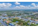 Wide aerial view of a waterfront community with many houses and canals at 15228 Chinook Way, Port Charlotte, FL 33981