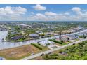 Aerial perspective showcasing a neighborhood with water access and various houses at 15228 Chinook Way, Port Charlotte, FL 33981