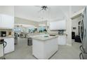 Bright kitchen with white cabinetry, an island, and views to the Gathering room at 15626 Meacham Cir, Port Charlotte, FL 33981