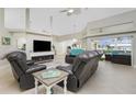 Spacious living room featuring a fireplace and comfortable leather seating at 15626 Meacham Cir, Port Charlotte, FL 33981