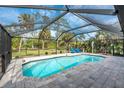 Relaxing screened pool area with patio furniture at 1651 Maria St, Englewood, FL 34223