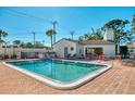 Inviting community pool with lounge chairs and patio area at 1730 Manasota Beach Rd # 110, Englewood, FL 34223