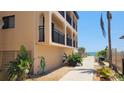 Side of condo building with walkway leading to pool and beach access at 1760 Gulf Blvd # 511, Englewood, FL 34223