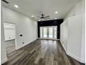 Bedroom with access to the pool, hardwood floors, and a ceiling fan at 19782 Midway Blvd, Port Charlotte, FL 33948