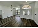 Bright entryway with double doors, hardwood floors, and a chandelier at 19782 Midway Blvd, Port Charlotte, FL 33948