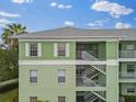 Light green building exterior with white accents and stairs at 2121 Heron Lake Dr # 301, Punta Gorda, FL 33983