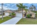 Single-story house with attached garage and driveway at 215 Australian Dr, Rotonda West, FL 33947