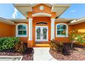 Front entrance with double doors, columns, and landscaping at 2194 Wenona Dr, North Port, FL 34288