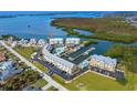 Bird's-eye view of waterfront community, showing condos, marina, and boat at 2424 Placida Rd # C101, Englewood, FL 34224