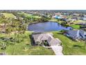 Property features a lake view and lush landscaping at 252 Medalist Rd, Rotonda West, FL 33947