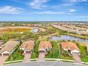 Aerial view of a tan house in a residential neighborhood at 26906 Weiskopf Dr, Englewood, FL 34223