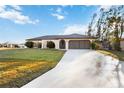 Single-story home with a large grassy yard and driveway at 4204 Cockrell St, Port Charlotte, FL 33948