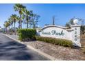 Forest Park community entrance sign with palm trees and landscaping at 4260 Placida Rd # 18C, Englewood, FL 34224