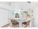 Kitchen with breakfast bar, white cabinets, and quartz countertops at 5000 Gasparilla Rd # Dc307, Boca Grande, FL 33921