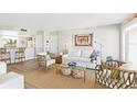 Bright living room featuring a comfy white couch and wicker chairs at 5000 Gasparilla Rd # Dc307, Boca Grande, FL 33921